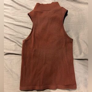 Brand is unknown but is a size Small. Brown colored turtleneck.